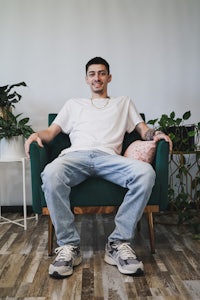 a man sitting on a green chair